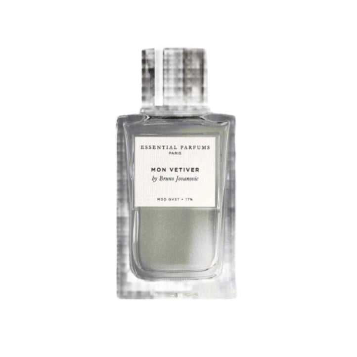 Perfume bottle labeled 'Essential Parfums' with natural elements on a gray background