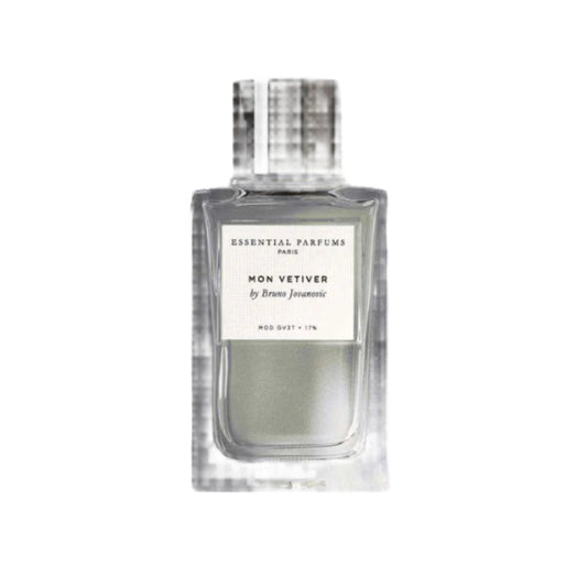 Perfume bottle labeled 'Essential Parfums' with natural elements on a gray background